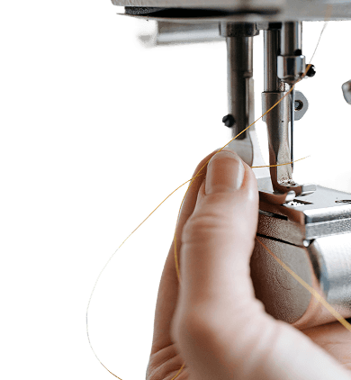 Close up of a sewing machine and hand